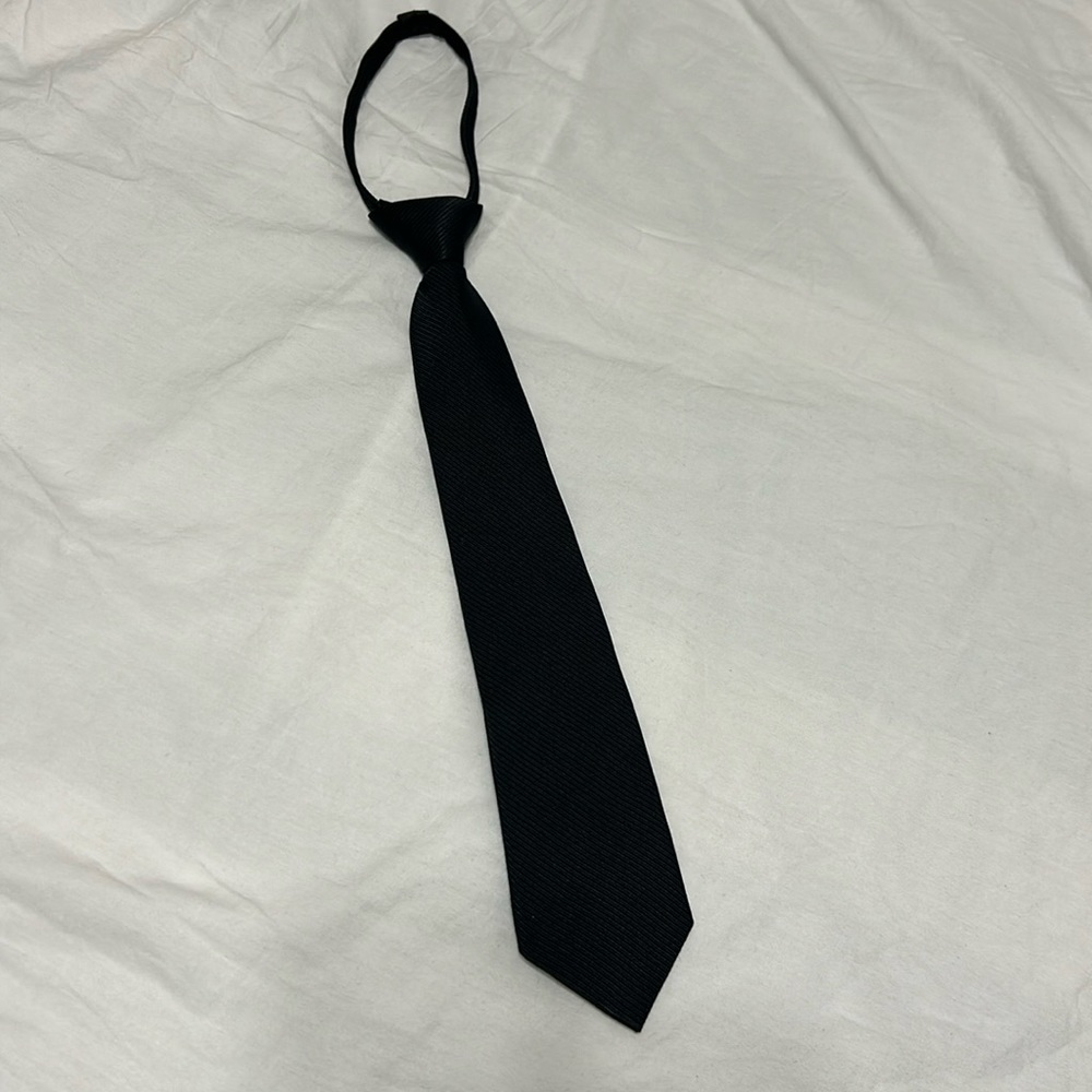 Boys tie in black, zipper adjustable. Preowned great condition.